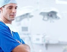 Doctor standing with folded arms Rethink restrictions on private health insurance