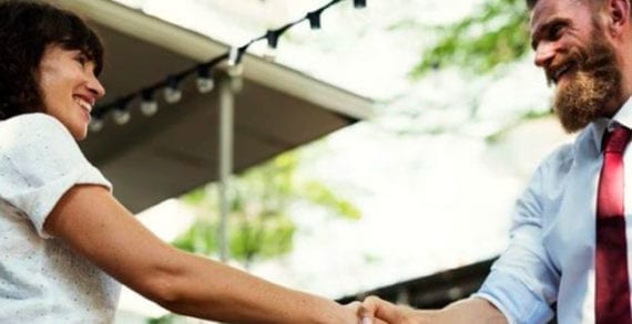 Man and woman shaking hands Instead of expressing contempt, embrace tolerance